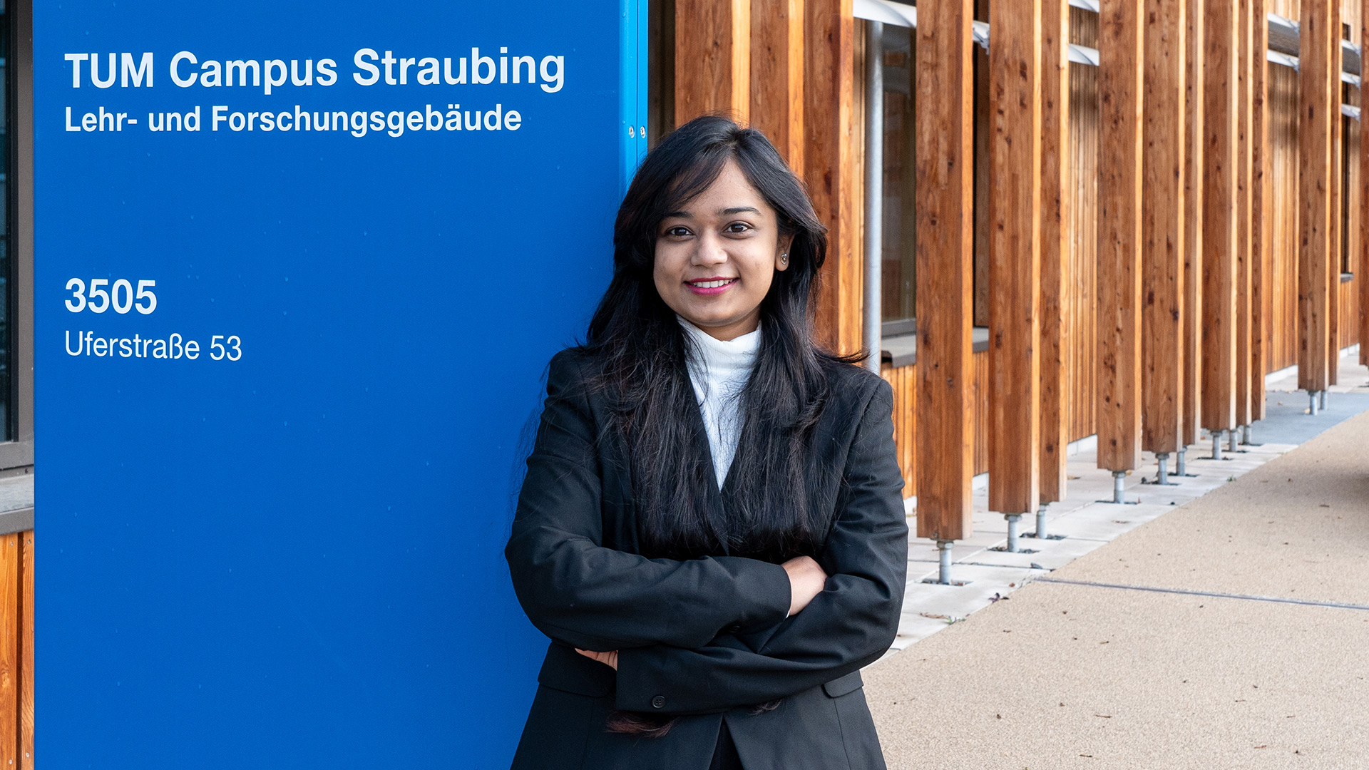 Pallabi Bhuyan next to the TUMCS sign in front of Uferstraße 53